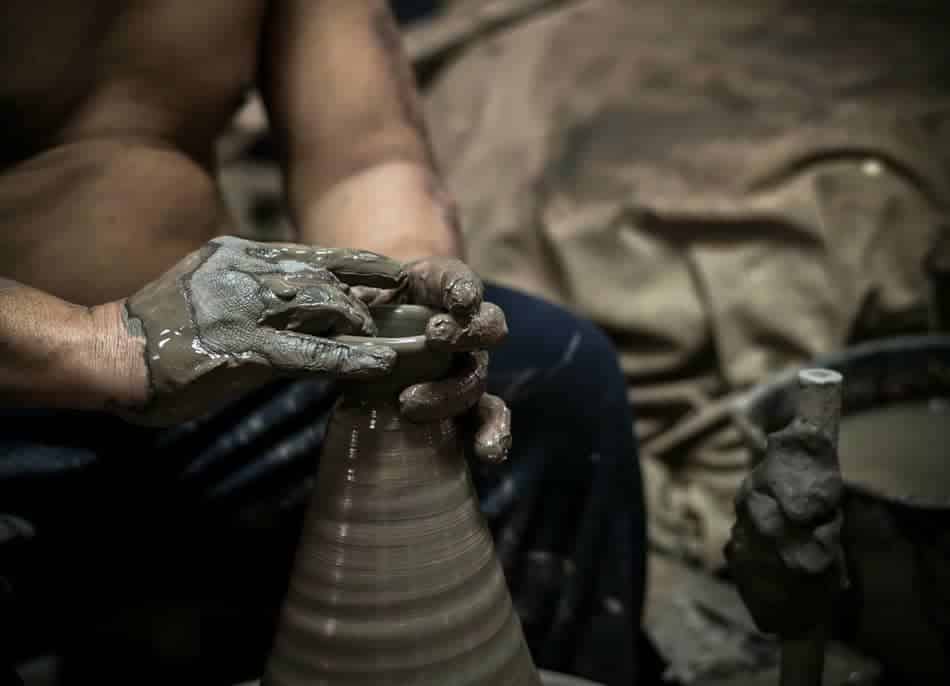 Hands shaping clay on a pottery wheel symbolizing identity-based habits and personal growth through repetition