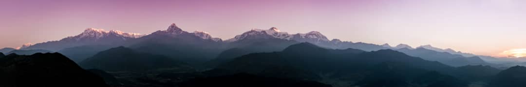 Mountain Peaks at Sunrise Mountain peaks beneath a soft sunrise sky