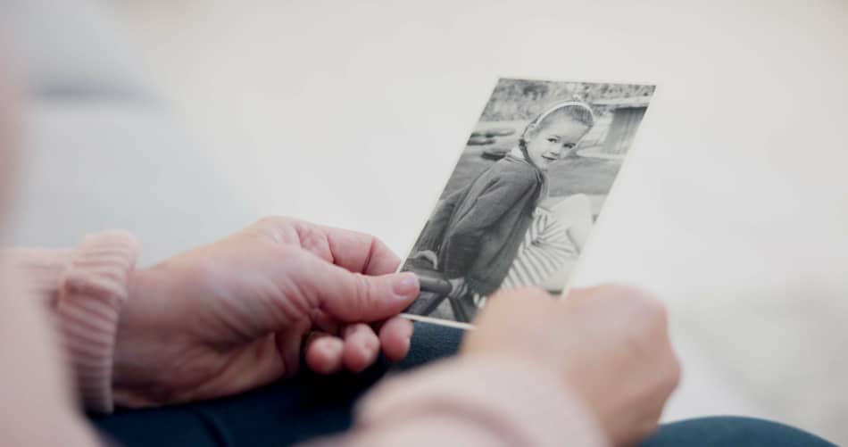Person holding an old black-and-white photograph