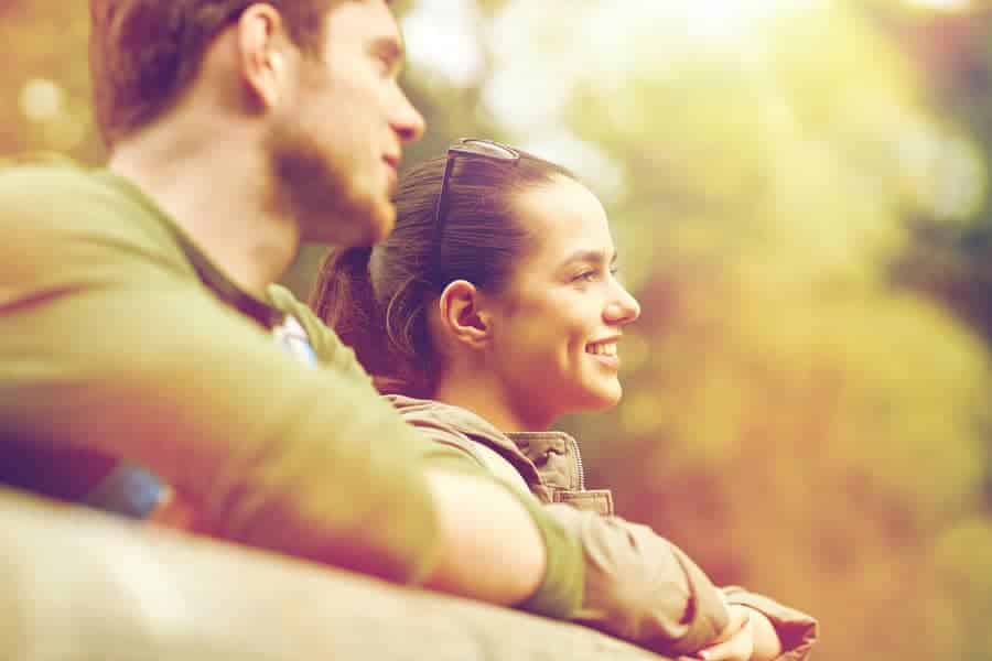 Two people sitting quietly together outdoors in daylight.