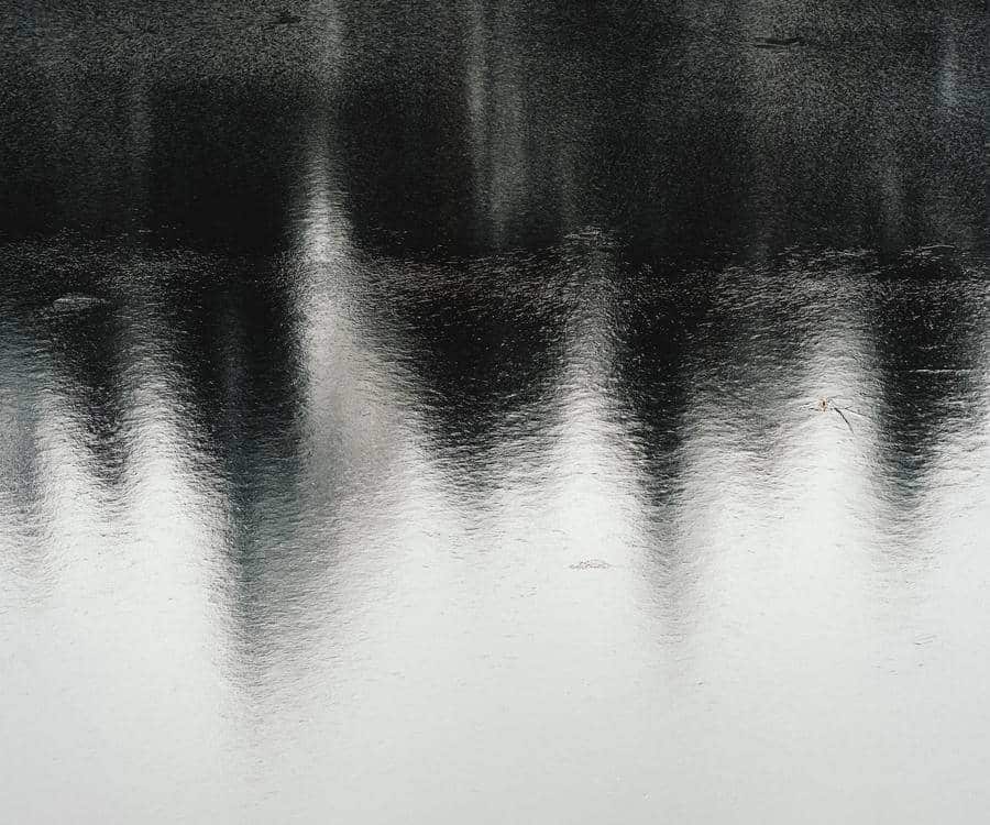 Soft reflection on still water, suggesting gentle awareness and noticing patterns.